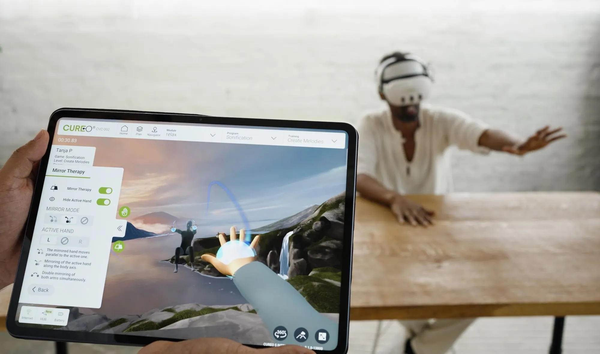 Terapeuta dirige una sesión de CUREO desde la tablet mientras el paciente, con el visor, interactúa con el entorno virtual